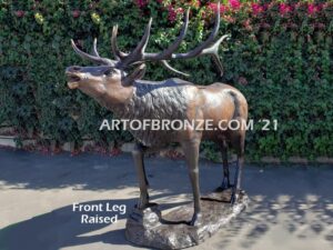 Heroic bronze bull elk standing on rocky base design with head raised in bugling position