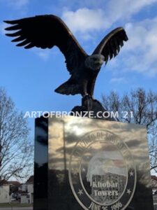 Khobar Towers Eagle war Memorial outdoor monumental statue of an eagle landing atop granite pillar