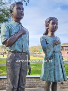 Pledge Allegiance wonderful outdoor bronze sculpture featuring two young kids with right hand on their hearts