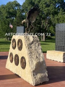 Southern Lyon County All Veterans Eagle war Memorial outdoor monumental statue of an eagle landing atop stone pillar
