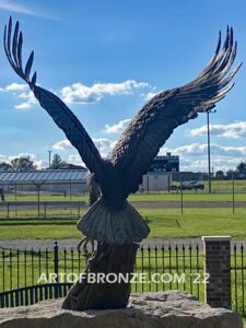 Southern Lyon County All Veterans Eagle war Memorial outdoor monumental statue of an eagle landing atop stone pillar