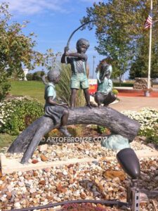 Fun Day outdoor bronze sculpture of three kids playing on huge bronze arched log