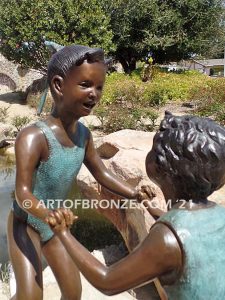 Dance Around bronze sculpture of boy & girl holding hands and playing together
