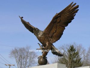 Eagle Veteran Memorial outdoor monumental statue of an eagle landing atop granite pillar