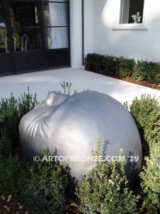 Expression sculpture of massive bronze face for outdoor and garden display