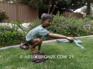 Frog Catching outdoor bronze fountain sculpture of boy grasping bullfrog that can spray water