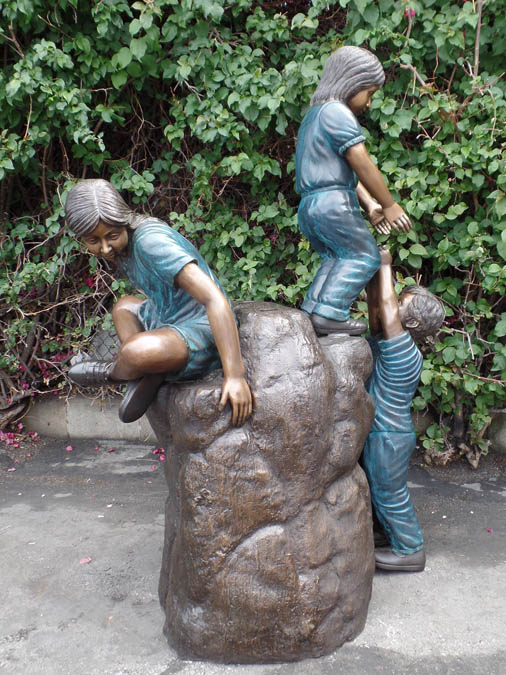 High Adventure bronze sculpture of children playing on bronze rock for park or school playground