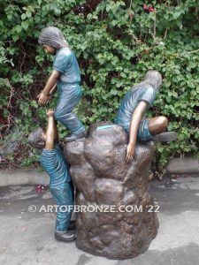 High Adventure bronze sculpture of children playing on bronze rock for park or school playground