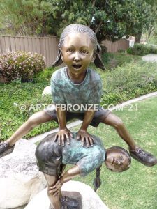 Leap Frog garden bronze sculpture of girl vaulting over crouched girl