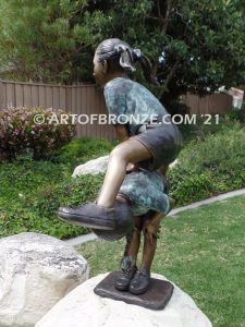 Leap Frog garden bronze sculpture of girl vaulting over crouched girl