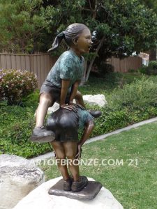 Leap Frog garden bronze sculpture of girl vaulting over crouched girl