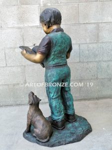 Waiting for Attention bronze sculpture of young boy reading his favorite novel