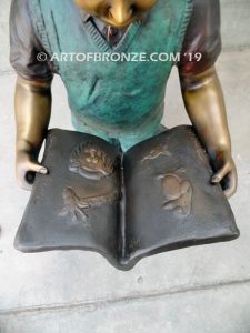 Waiting for Attention bronze sculpture of young boy reading his favorite novel