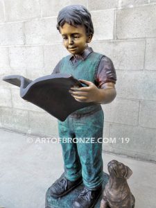 Waiting for Attention bronze sculpture of young boy reading his favorite novel