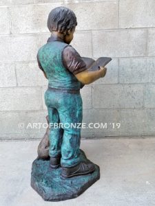 Waiting for Attention bronze sculpture of young boy reading his favorite novel