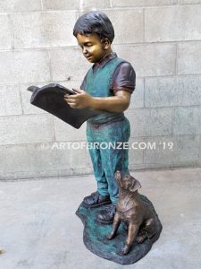 Waiting for Attention bronze sculpture of young boy reading his favorite novel