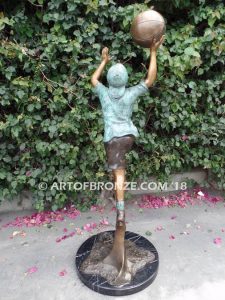 Layup bronze sculpture of life-size basketball player shooting basketball