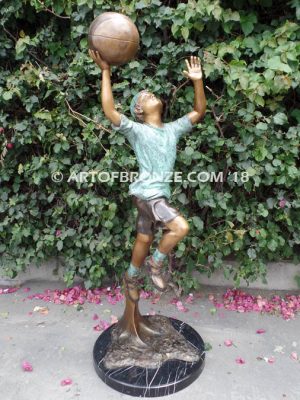 Layup bronze sculpture of life-size basketball player shooting basketball