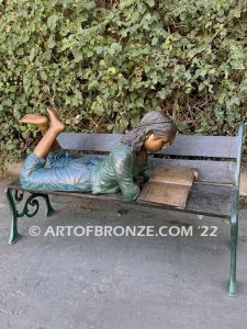 Best in Class bronze sculpture of young girl resting on bench reading her favorite novel