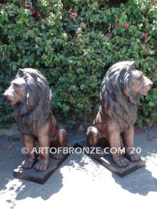 Kings of the Castle high quality cast bronze African lion pair sitting next to each other