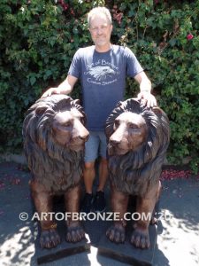 Kings of the Castle high quality cast bronze African lion pair sitting next to each other