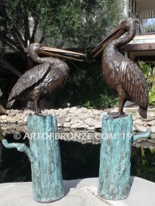 Shoreline Patrol bronze statue of playful pelicans on bronze tree stumps