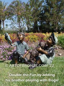 Best Buddies bronze sculpture of young boy petting his dog on his lap