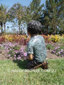 Frog Fun outdoor bronze fountain sculpture of boy grasping bullfrogs that can spray water