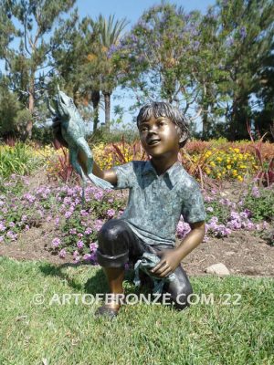 Frog Fun outdoor bronze fountain sculpture of boy grasping bullfrogs that can spray water