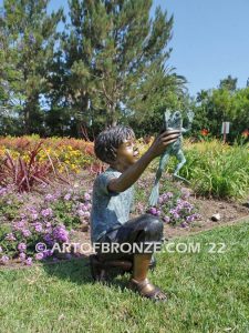 Frog Fun outdoor bronze fountain sculpture of boy grasping bullfrogs that can spray water