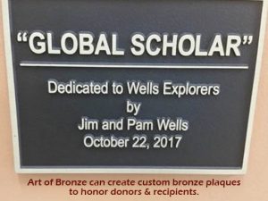 Library & elementary bronze statue of young boy reading book atop bronze world