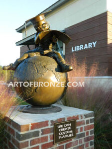 Global Scholar bronze sculpture of boy sitting on globe wearing graduation cap and reading diploma