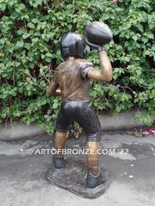 Quarterback Leader bronze sculpture of football boy wearing helmet, pads and jersey