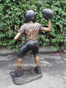 Quarterback Leader bronze sculpture of football boy wearing helmet, pads and jersey