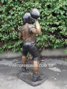 Quarterback Leader bronze sculpture of football boy wearing helmet, pads and jersey