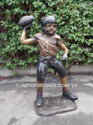 Quarterback Leader bronze sculpture of football boy wearing helmet, pads and jersey