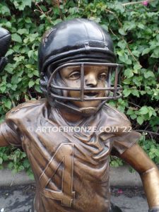 Quarterback Leader bronze sculpture of football boy wearing helmet, pads and jersey