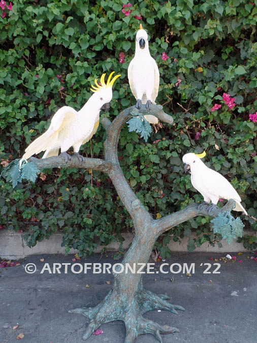 Ready to Entertain outdoor statue of life-size white and yellow crested feathered cockatoos