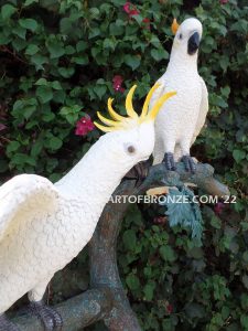 Ready to Entertain outdoor statue of life-size white and yellow crested feathered cockatoos