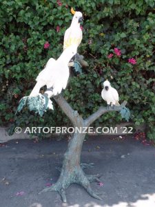 Ready to Entertain outdoor statue of life-size white and yellow crested feathered cockatoos