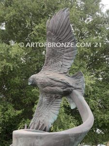 Spirit Above bronze sculpture of life-size flying hawks on bronze base for hotel entrance