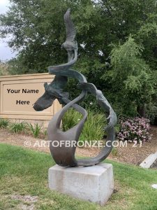 Spirit Above bronze sculpture of life-size flying hawks on bronze base for hotel entrance