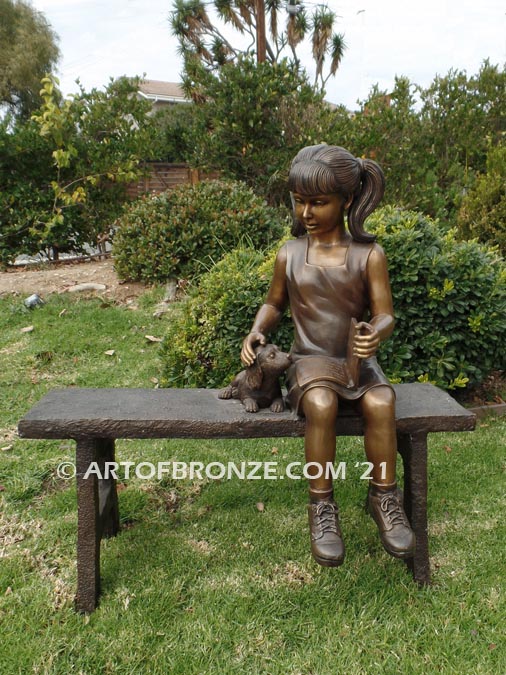 Study Buddy bronze sculpture of seated girl playing with her dog