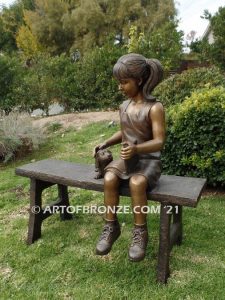 Study Buddy bronze sculpture of seated girl playing with her dog