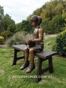 Study Buddy bronze sculpture of seated girl playing with her dog