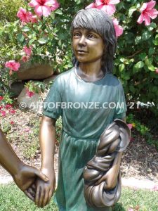 Taking a Stroll outdoor bronze sculpture brother and sister walking together holding hands