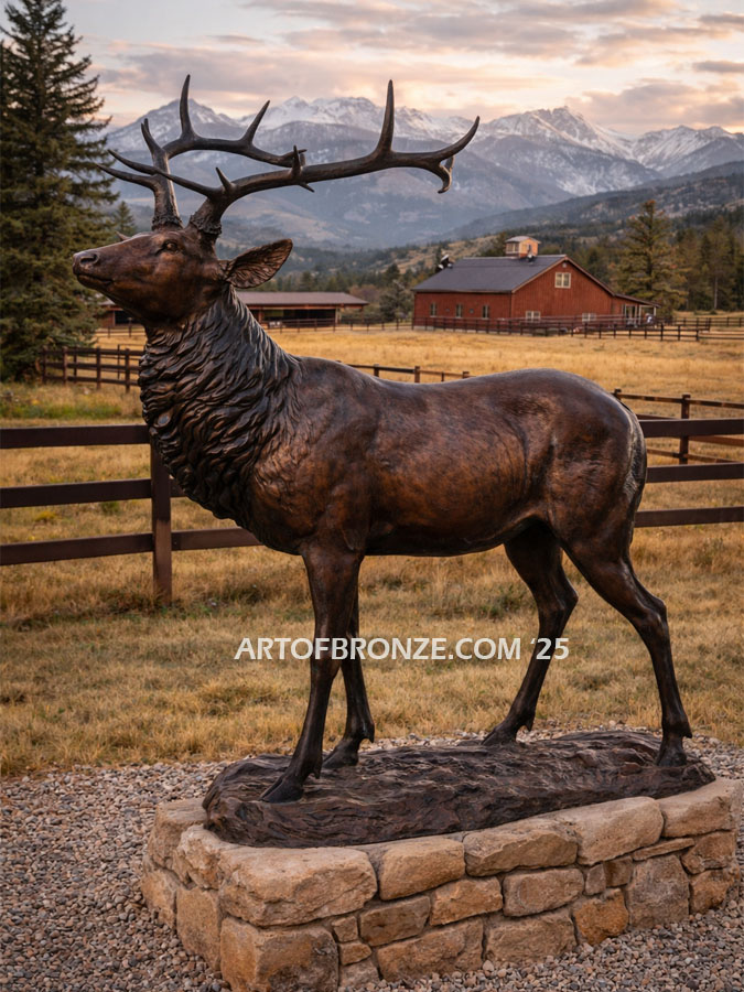 Heroic bronze bull elk standing on rocky base design with head raised in bugling position