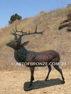 Heroic bronze bull elk standing on rocky base design with head raised in bugling position