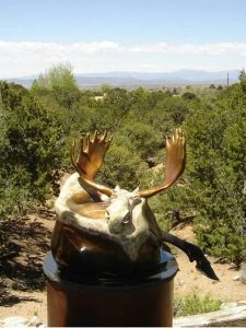 Contemporary resting moose bronze statue designed for home or office