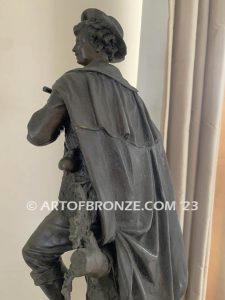 Young flautist classical bronze statue of boy holding flute with dog resting alongside